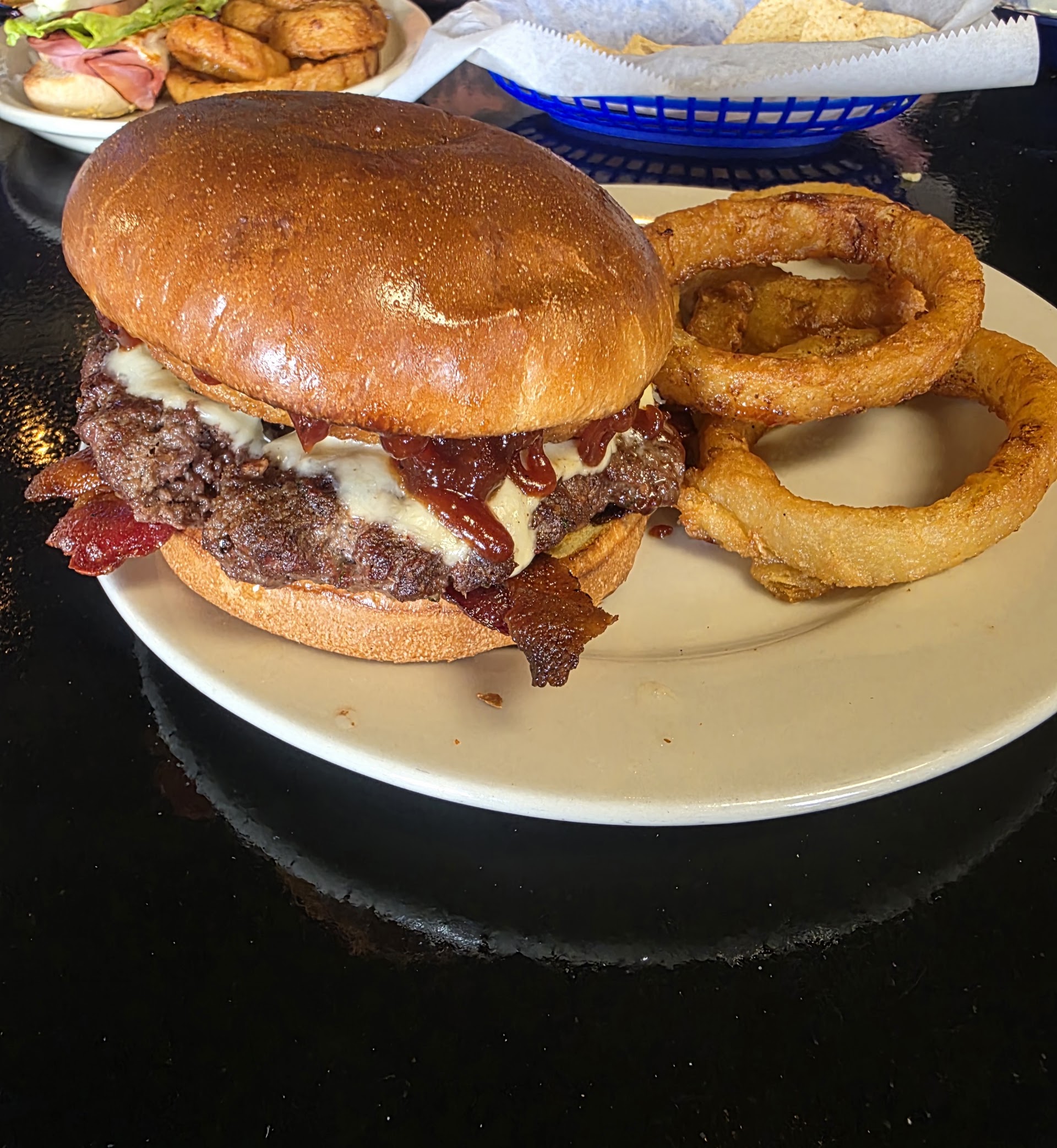 Burger and onion rings served at Kentucky Bluebird Grill & Pub